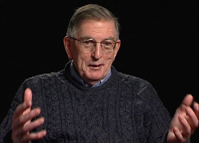 William Barry, S.J., a white man with greying hair and glasses, wearing a dark navy sweater.