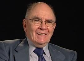 Fr. Jean-Yves Calvez, a older balding white man with glasses, wearing a dark grey suit and navy tie.