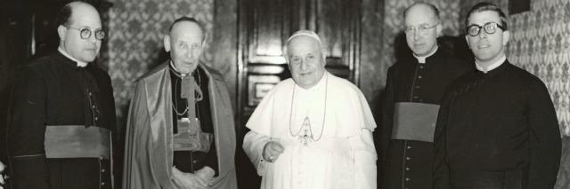 Pope John XXIII meets with his newly appointed Secretariat for Promoting Christian Unity on January 7, 1961. From left to right: Msgr. Jean-François Arrighi, Cardinal Augustin Bea, Pope John, Msgr. Johannes Willebrands, and Fr. Thomas Stransky, C.S.P.