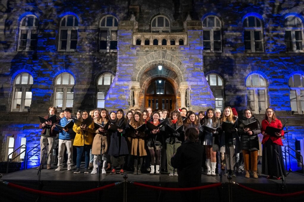 The Georgetown University Concert Choir, a group of about 30 mixed voice singers, perform in front of Healy Hall.