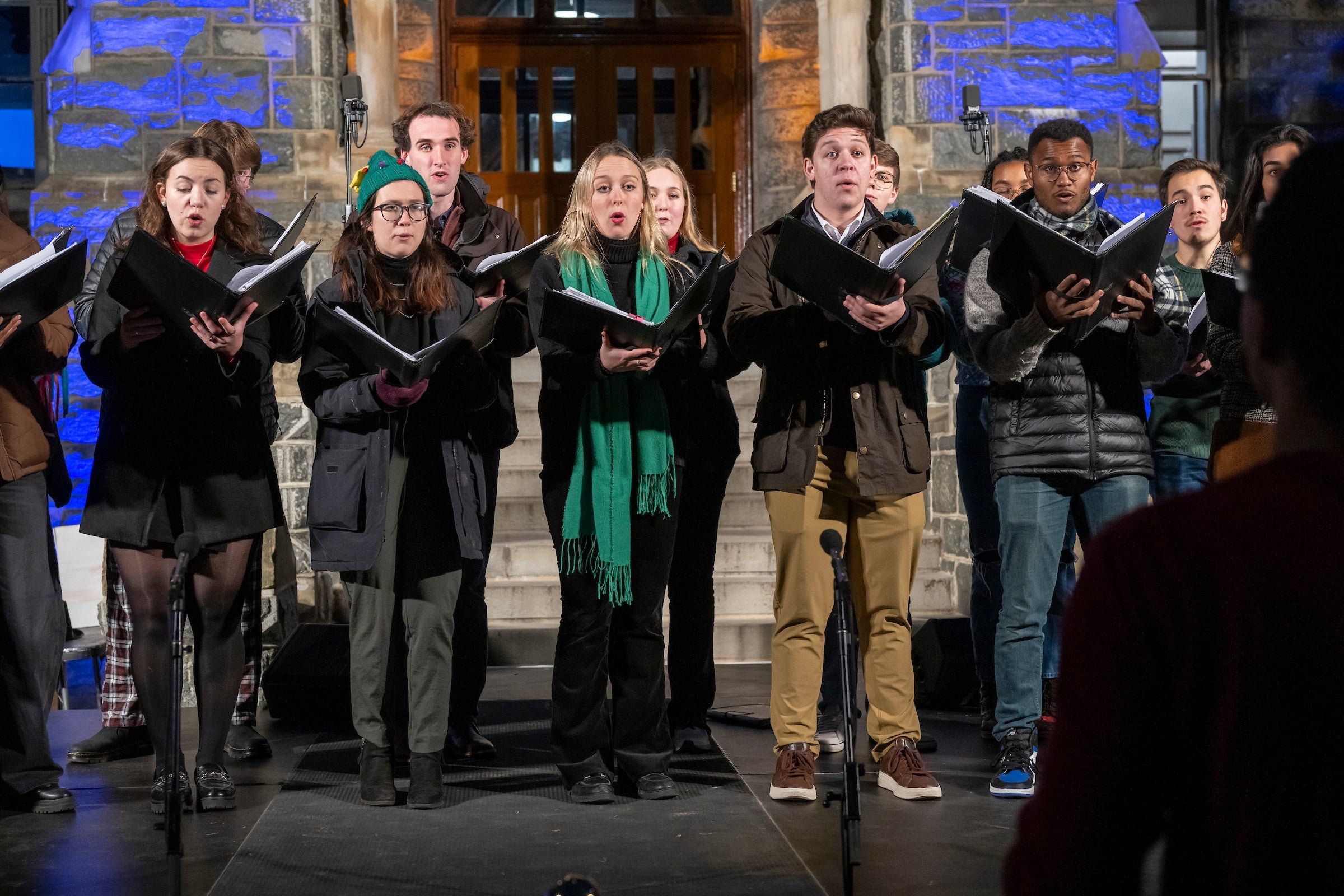 A close up of the Georgetown University Chamber Singers, a smaller mixed-voice group, singing in front of Healy Hall