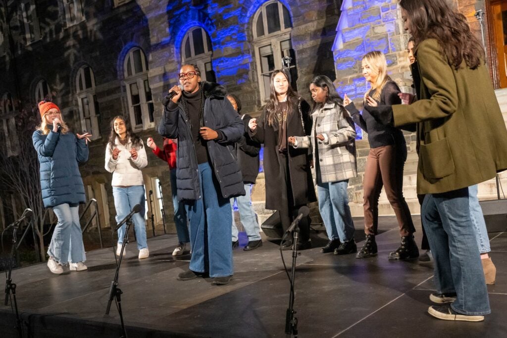 The Georgetown GraceNotes, an acapella group of about 10 soprano, alto, and tenor singers, perform in front of Healy Hall.