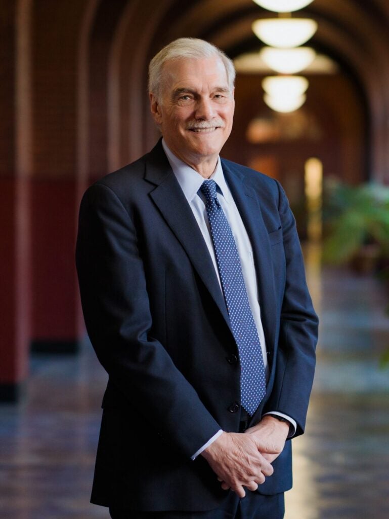Robert Groves, an older white man wearing a suit and tie.
