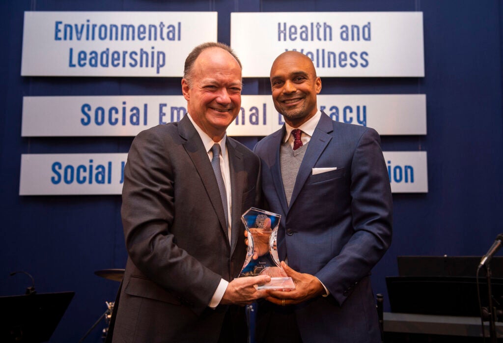 John J. DeGioia poses with Hawah Kasat. Both area holding the Legacy of a Dream award.