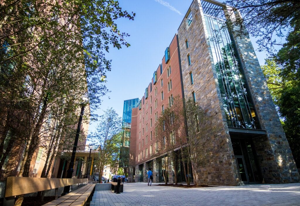 The exterior of Arrupe Hall, a 7-story building whose facade is a combination of brick, stone, and glass.