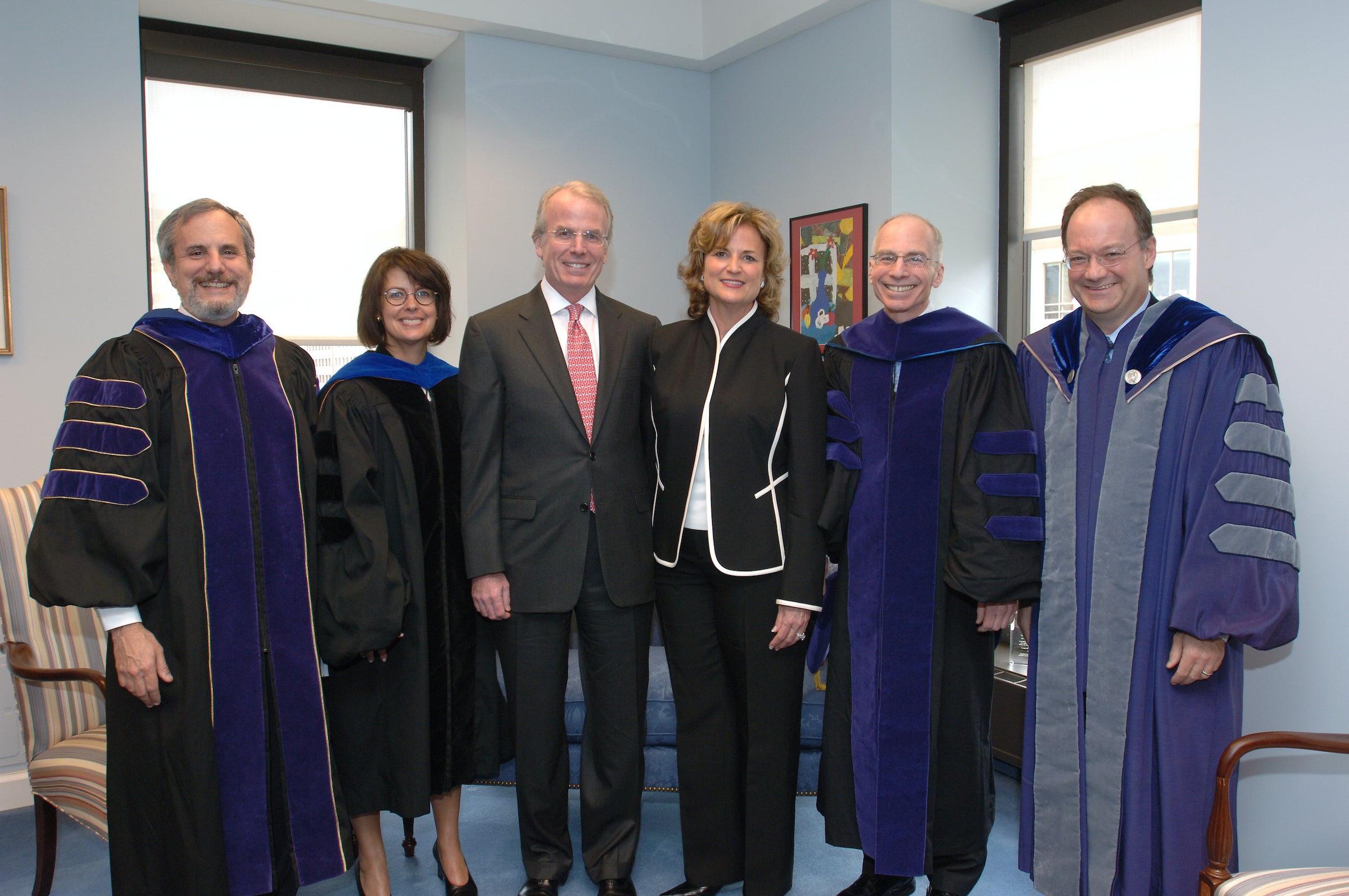Timothy and Linda O'Neill pose with President DeGioia and three faculty members, dressed in academic regalia.