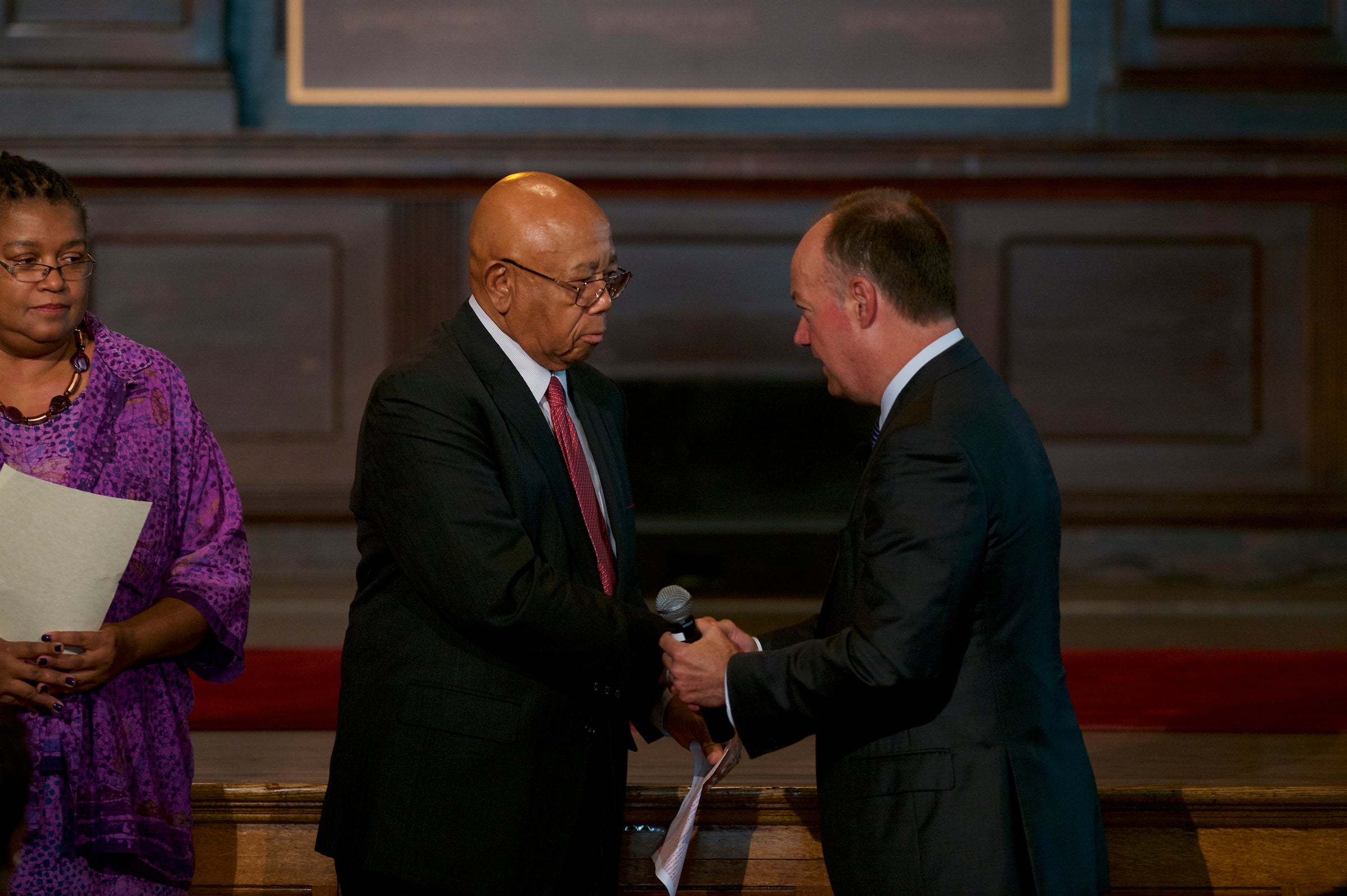 President DeGioia shakes hands on stage with Joseph Stewart.