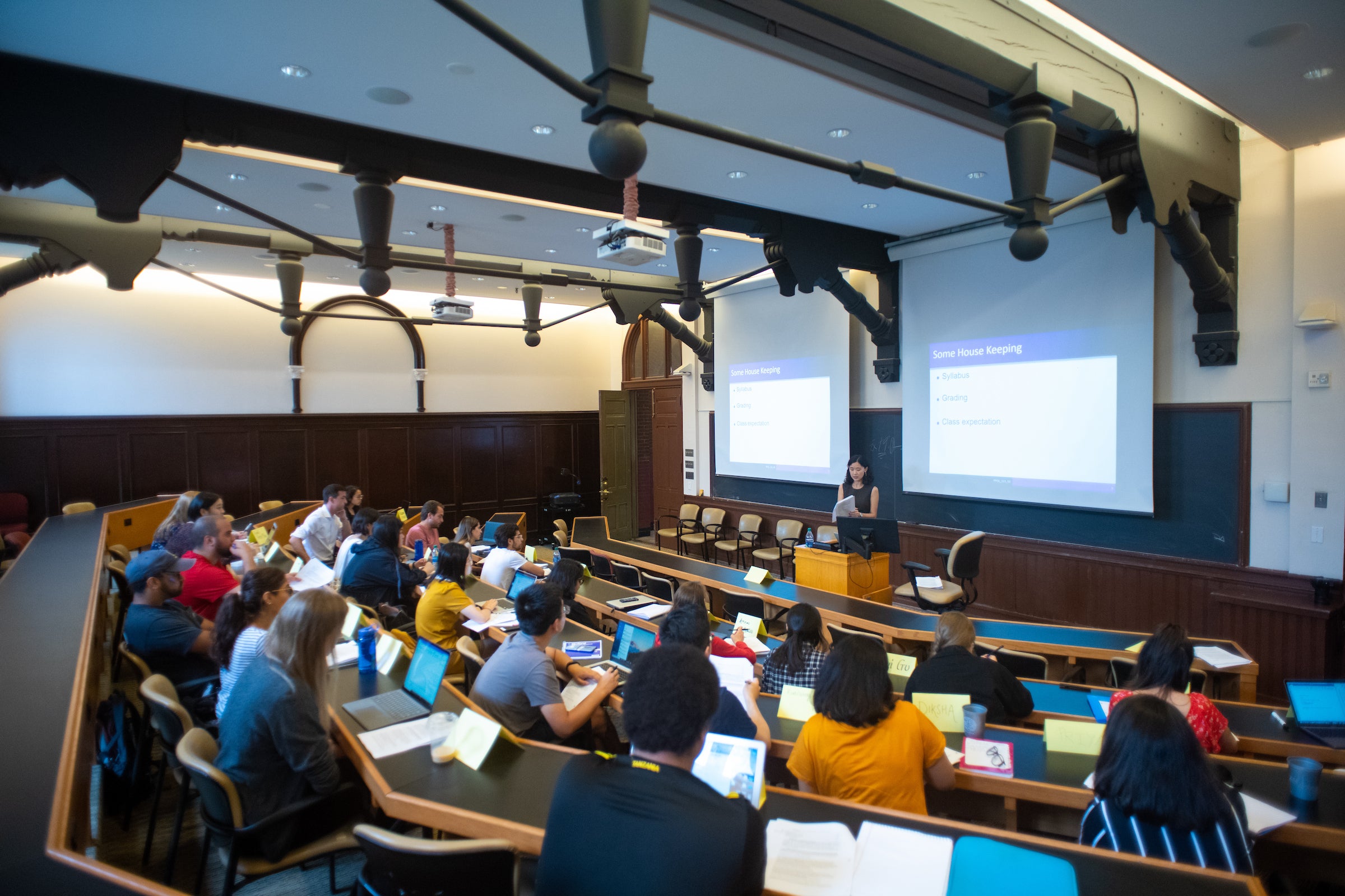 Wide angle view of a lecture hall filled with students.
