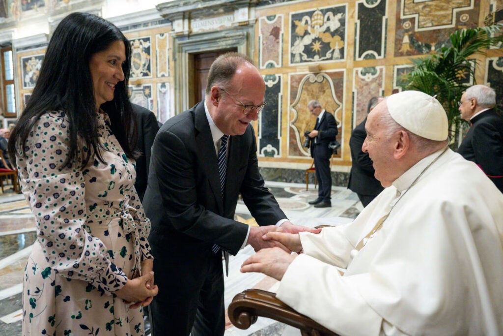 John J and Theresa DeGioia stand and are greeted by Pope Francis.