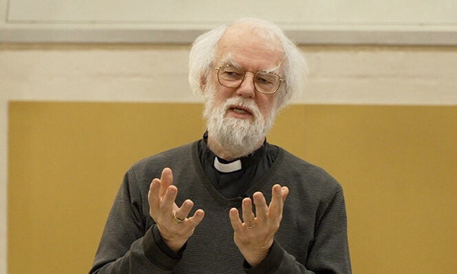 Former Archbishop of Canterbury Rowan Williams, an older man with white hair and facial hair, addresses an audience.