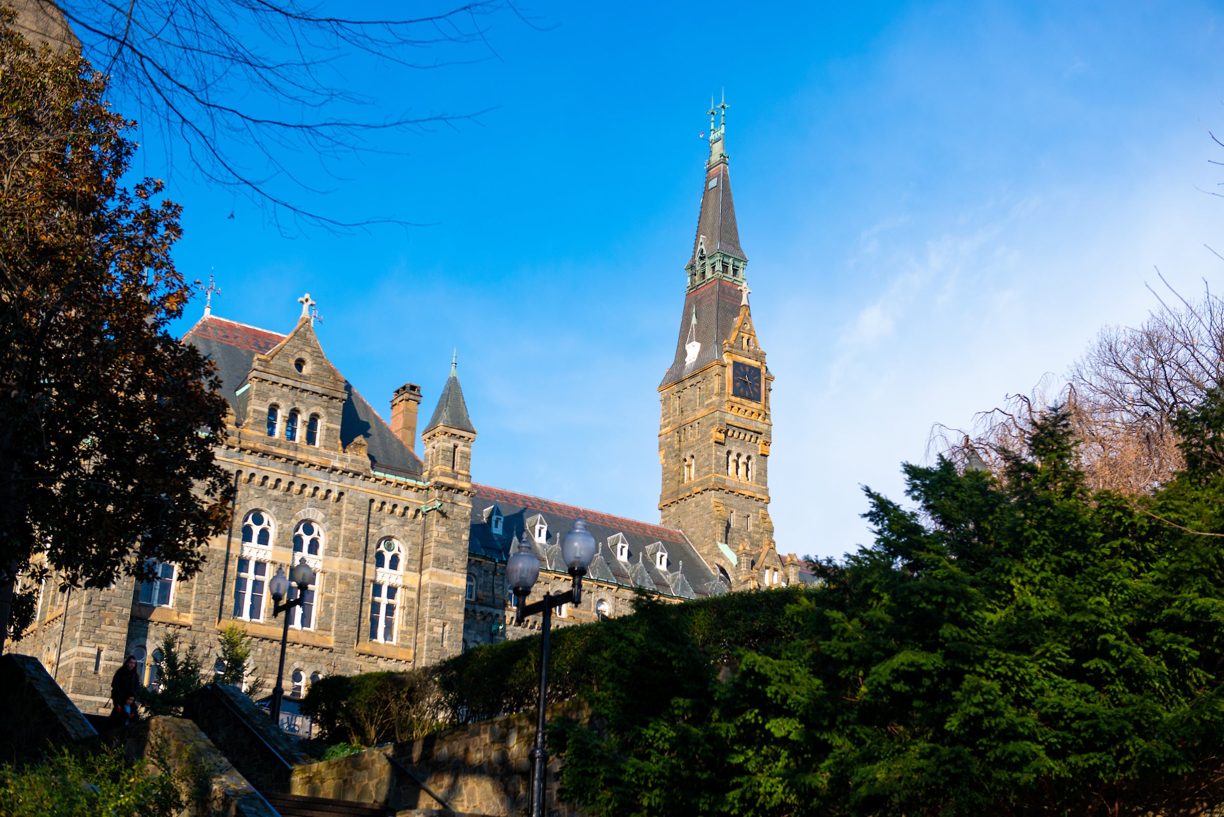 Healy Hall, a neo-gothic style building, photographed from below on a clear fall day.